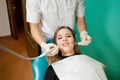 Dentist removes tartar from his patientÃ¢â¬â¢s teeth